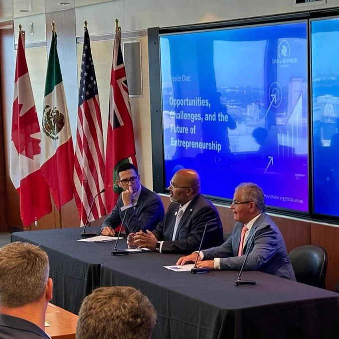 Close up of panelists featuring Assistant Secretary Venkataraman. They are seated speaking into microphones. 
