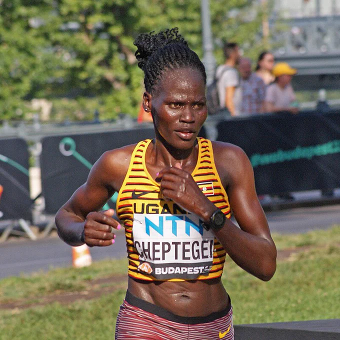 Rebecca Cheptegei running in Ugandan uniform 