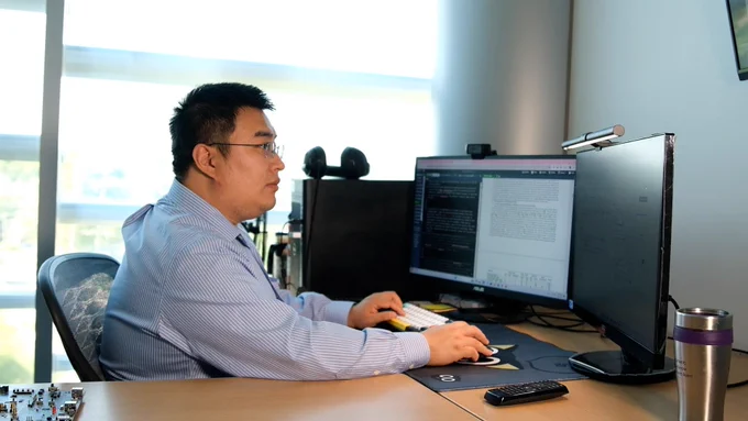 Xiaolong Guo works at his computer.