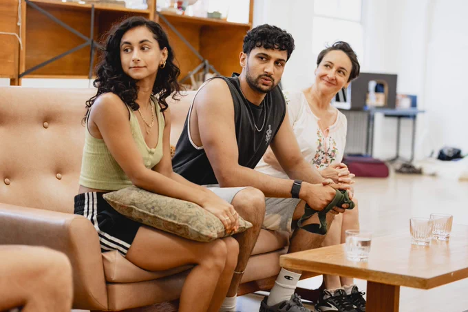 Three actors sat on the sofa