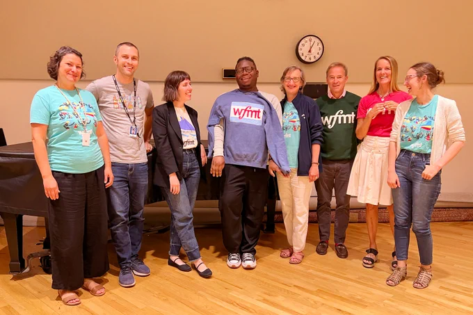 Staff-members sport smiles and WFMT shirts during the one-day Bach to School drive