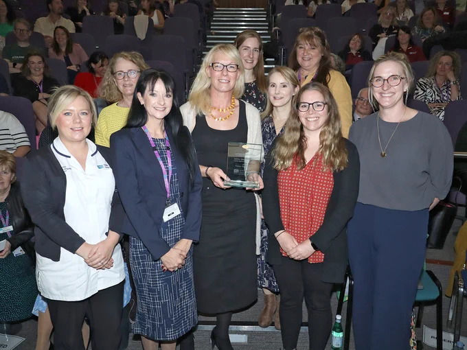 Group of staff with their SQB Award at the celebration event.