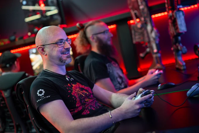 Photo depicting Splash Damage developers revisiting Gears 5, playing it in the Splash Damage Studio.