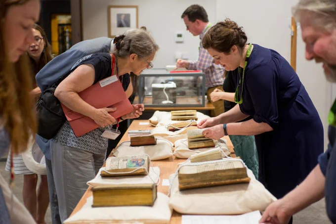 Photograph of people looking at a display of medieval records at the International Medieval Congress 2018.