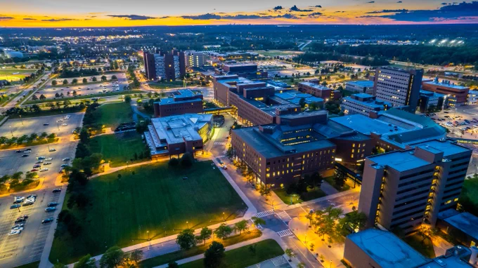 Aerial view of illuminated campus buildings at dusk