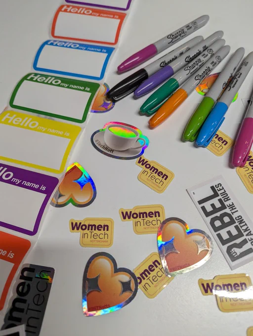 Picture of Women in Tech stickers and hello name tags with brightly coloured Sharpies pens