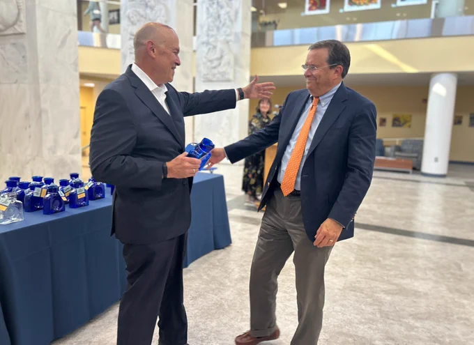 Dr. Clay Marsh congratulates Dr. Marc Haut.