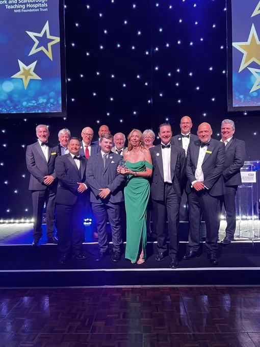The team receiving their award onstage.