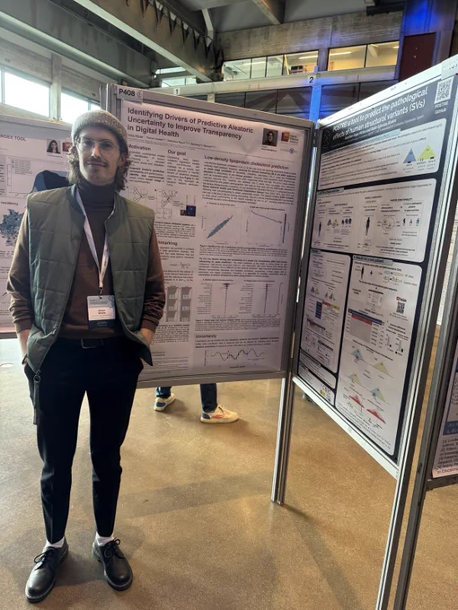 Simon Witzke happily standing in front of his poster.