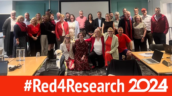Members of the NIHR community wearing red looking at the camera. Text saying #Red4Research 2024