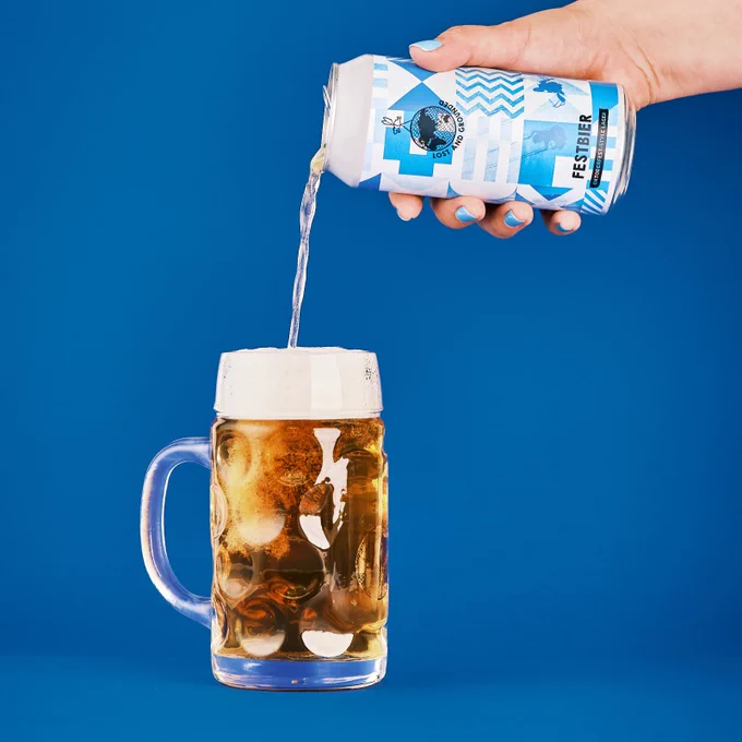 A can of our 2024 Festbier being poured in to a beer stein