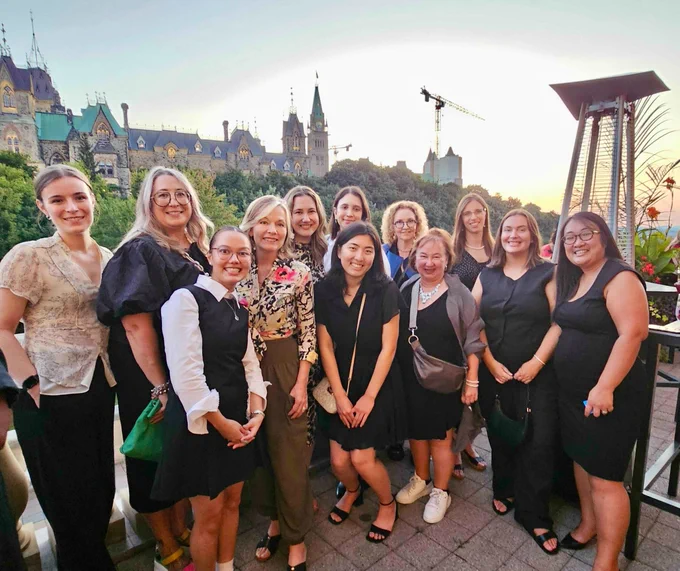 A group photo with our Compass Rose group outside at Women On The Hill event.