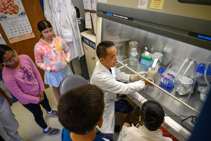 MU researcher and clinician Yujiang Fang, seated with participants in a Mizzou “mini-medical school” camp for sixth through eighth graders. Photo by Marshall Danner, MU Extension.