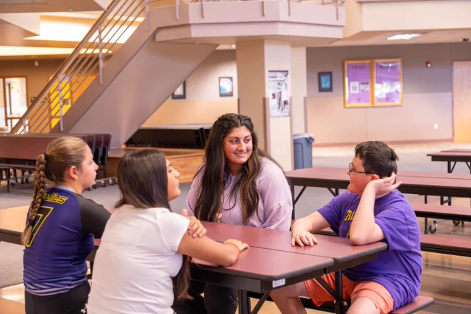 Counselor Sarah Nazari meets with a group of students at lunch