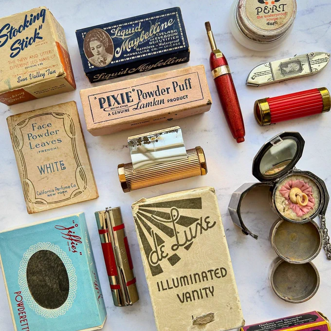 Array of vintage lipstick, face powder and compacts
