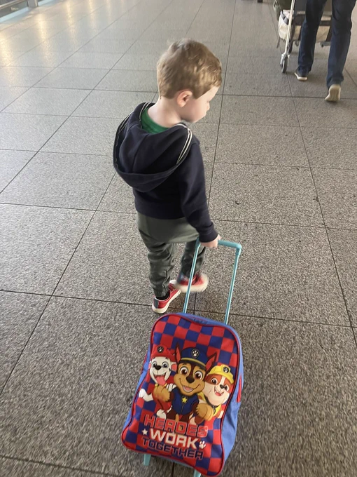 Boy carrying suitcase