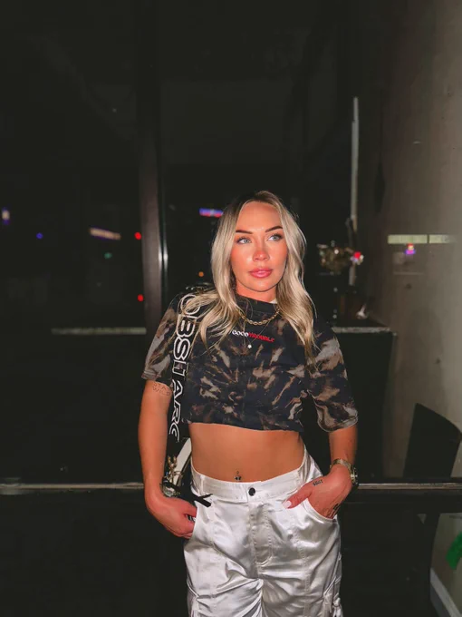 Women’s black and bleach tie die crop top with Good Trouble text.