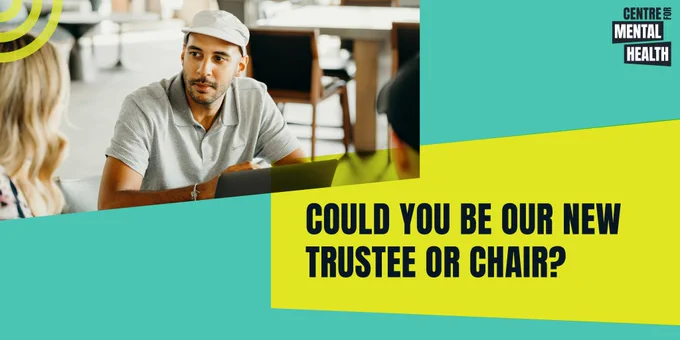 A man in a light grey polo shirt and white cap is sitting at a table with his laptop, in conversation with two of his colleagues in an office setting. Yellow box with black caps text reads: Could you be our new trustee or chair of trustees?