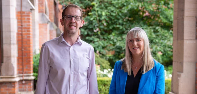 Image shows Professor Christopher Lloyd and Professor Gemma Catney. They are pictured in the cloisters at Queen's Lanyon Building.