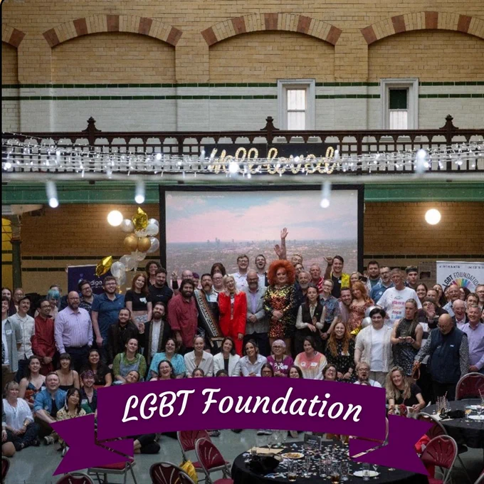 LGBT Foundation volunteers in a big group smiling at the camera.