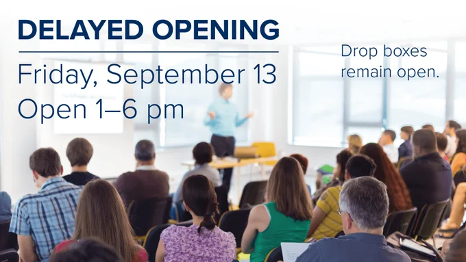 Image of staff members looking at a presenter with text overlaid that reads DELAYED OPENING Friday, September 13 Open 1-6 pm. Drop boxes remain open.