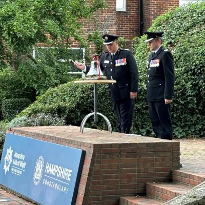 Fire officers ringing a bell to signal the end of the two-minute silence