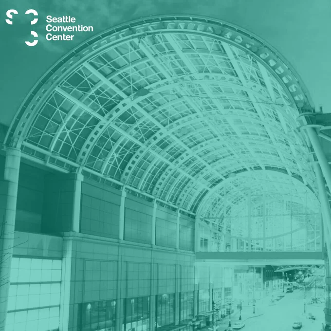 An image showing Seattle Convention Center's iconic arch illuminated in teal.