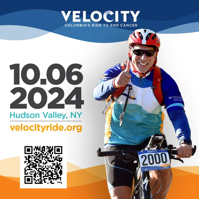 Image of a man on a bike giving a thumbs up