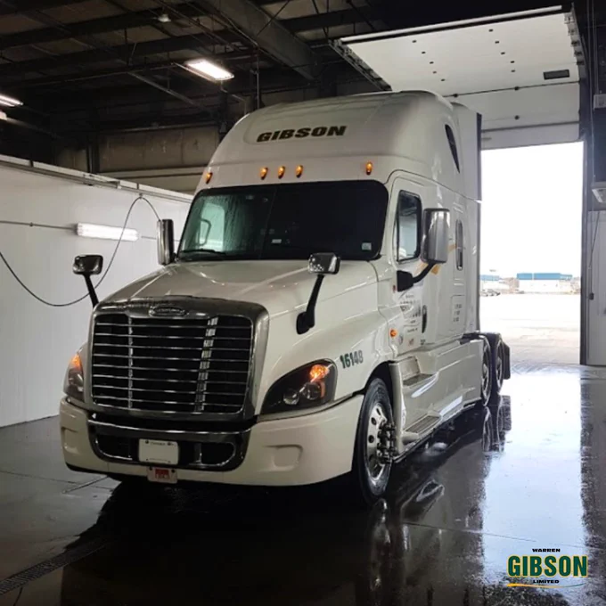 A photo of a Warren Gibson truck in the washing bay during daytime.