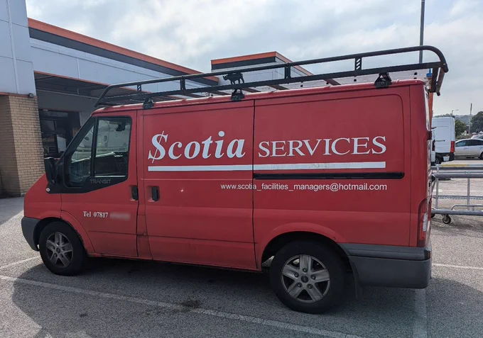 A work van showing the email address www.scotia_facilities_manager@hotmail.com to advertise a business