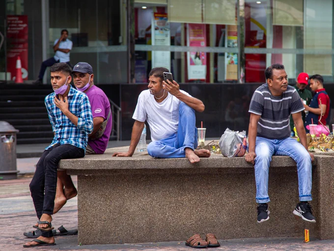 Nepali migrants calling home. Photo via Sydney Chan. 