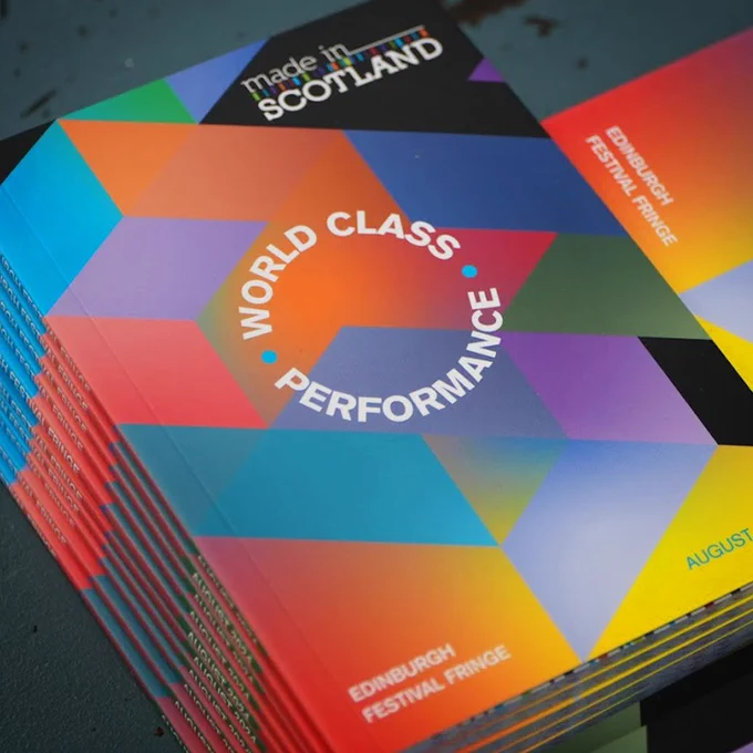 A stack of brightly coloured programmes for Made in Scotland 2024 at the Edinburgh Festival Fringe, bearing the words, 'world class performance'.