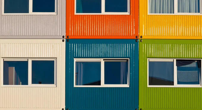 photograph a small apartments that look like a block of shipping containers