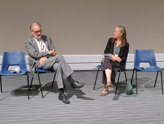 Ian Diamond and Alice Reid, sitting at front of lecture theatre on rather utilitarian chairs