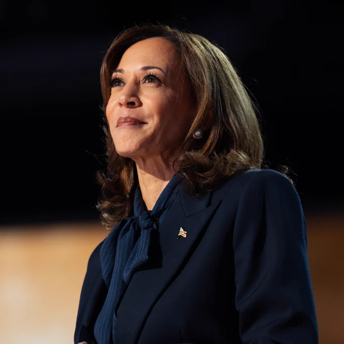 A photo of Vice President Kamala Harris smiling in a navy suit.