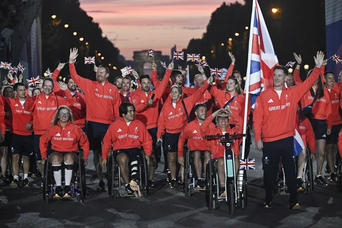 The ParalympicsGB team at the opening ceremony with the Union flag and the arc de triomphe in the background
