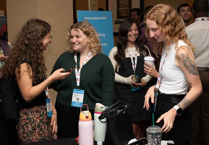 Four individuals are engaging in a conversation at a networking event. 