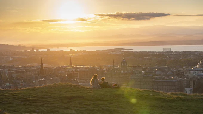 Edinburgh seen from Salisbury Crags: a cityscape with setting sun