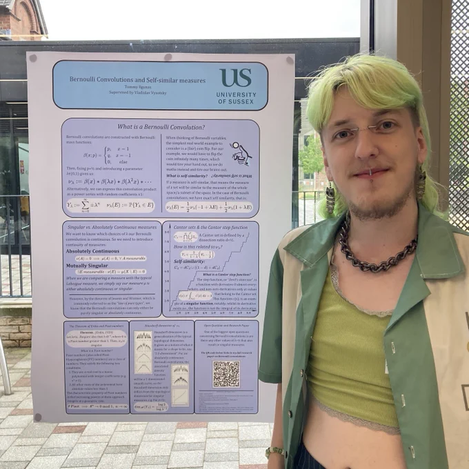 Student Tommy Ilgunas standing in front of their poster.