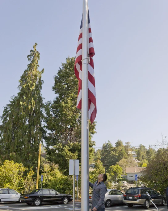 College of Marin
College student stands next to the campus flag pole with the American flag hanging.