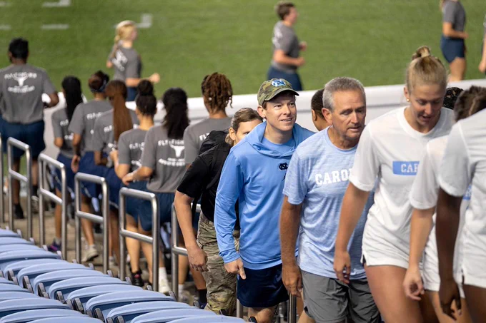 Chancellor Lee H. Roberts and others climb the stairs of Kenan Stadium at sunrise during the 9/11 Memorial Stair Climb at UNC