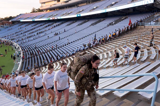 Students and community members climb the stairs of Kenan Stadium at sunrise during the 9/11 Memorial Stair Climb at UNC