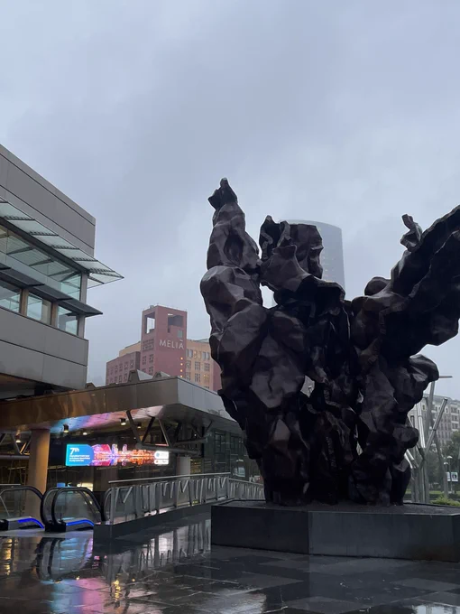 Photo of the outside of the conference centre with a sculpture