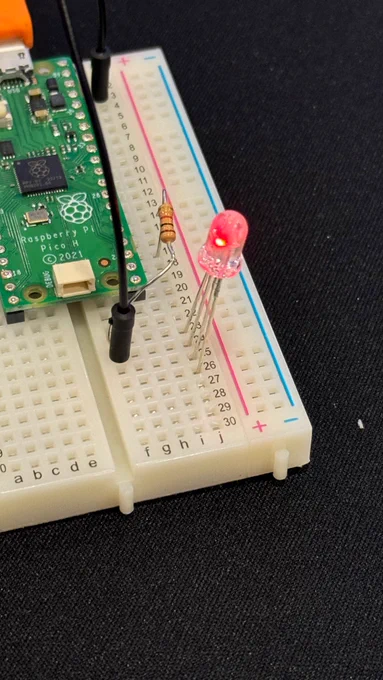A raspberry pi microcontroller running Picoruby and displaying a red LED.