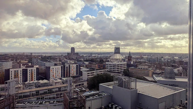 Liverpool's skyline, featuring the two cathedrals, the university, and the mersey river in the back. 