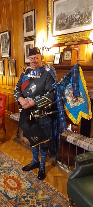 Pipe Major Hughes with the Pipe Banner for the RAF Pipes and Drums which was presented to HM The King at Balmoral on 25 August 2024.