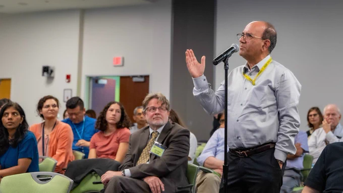 Photo of audience at Joram Piatogorsky Award Lecture (Anand Swaroop pictured at microphone).