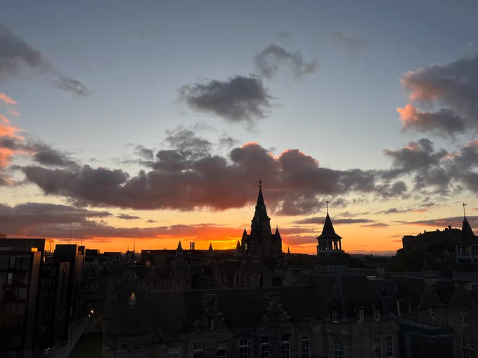 Edinburgh’s skyline with burning orange sunset and some dark clouds