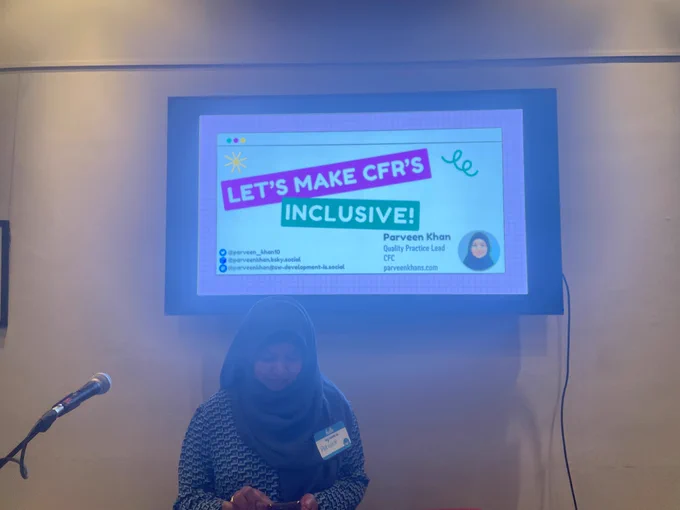 parveen Khan in front of title slide 