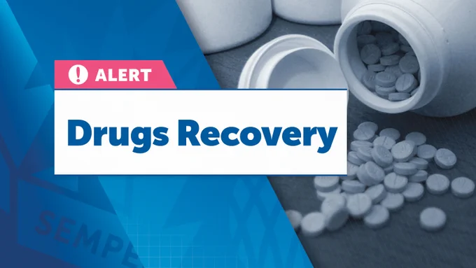 On the left side, a pink and white box with a warning icon and the word "ALERT" is prominently shown. Below this, a large white box contains the text "Drugs Recovery" in bold blue letters. The right side of the image features a blue-tinted, slightly blurred photograph of pills spilling out of an open bottle. "